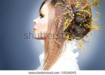 fashion portrait of a woman with mimosa in her hair