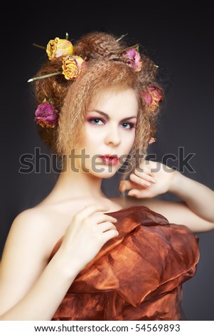 fashion portrait of a beautiful woman with nest of roses in her hair