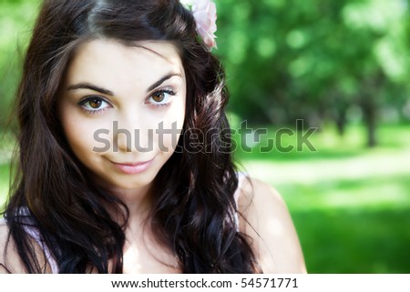 Beautiful woman in the summer park