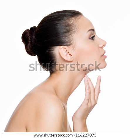 Beautiful woman cares for the skin neck- posing at studio isolated on white Beautiful woman cares for the skin neck- posing at studio isolated on white