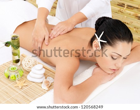 Woman Having Therapy Massage Of Back In The Spa Salon. Beauty Treatment Concept.