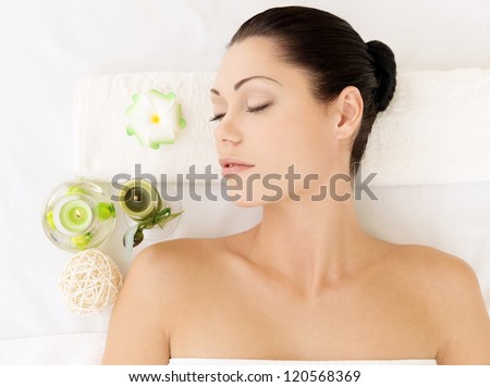 Relaxing white woman at beauty spa salon. Recreation therapy. Resting female with closed eyes