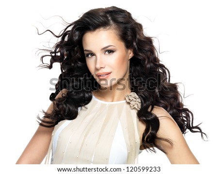 Beautiful brunette woman with beauty long curly hair. Fashion model with wavy hairstyle