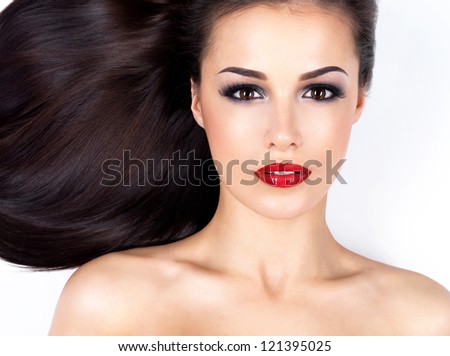 Photo of a beautiful woman with long straight brown hair looking at camera