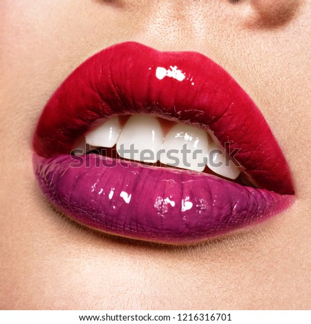 Close up view of beautiful woman lips with  gloss lipstick.. Open mouth with white teeth.  fashion makeup concept. Beauty studio shot. Gloss.