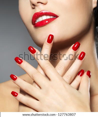 Young woman with fashion red nails and sensual lips Model posing in studio Young woman with fashion red nails and sensual lips Model posing in studio