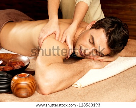 Masseur Doing Massage On Man Body In The Spa Salon. Beauty Treatment Concept.