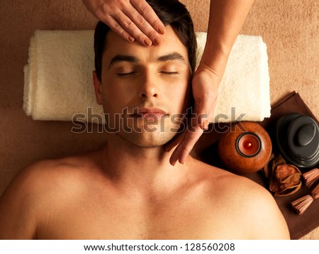 Masseur Doing Head Massage On Man In The Spa Salon.
