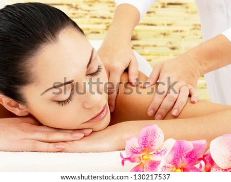Young Woman On Spa Massage Of Shoulder In The Beauty Salon.