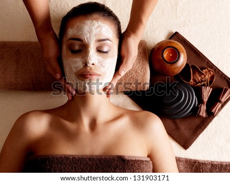 Spa Massage For Young Woman With Facial Mask On Face - Indoors