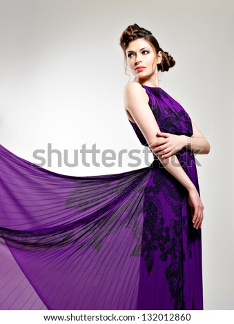 Beautiful fashion woman in violet long dress hairstyle with pigtails design