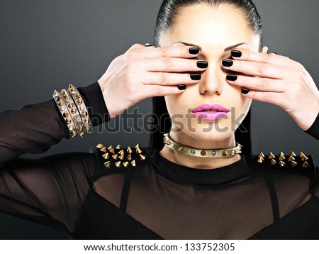 Fashion woman with black nails and bright pink lips.  Stylish girl with bracelet thorns on the neck