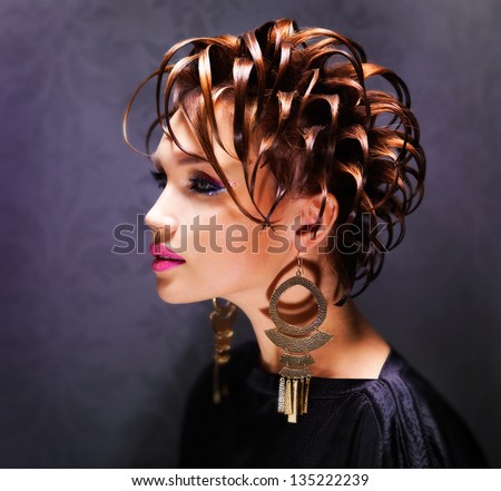 Beautiful woman with fashion  hairstyle and bright pink makeup - posing at studio.