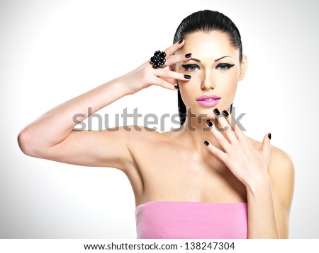 Face of the  beautiful sexy  woman with black nails and pink lips. Sexy girl with fashion makeup