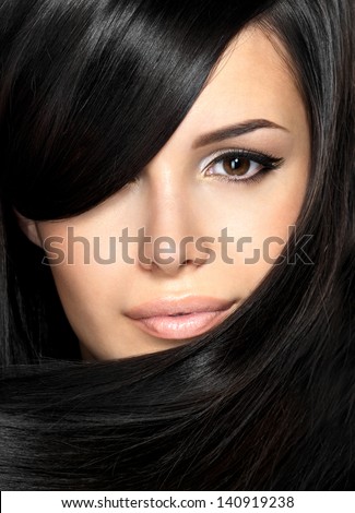 Beautiful woman with straight hair. Closeup portrait of a fashion model posing at studio.