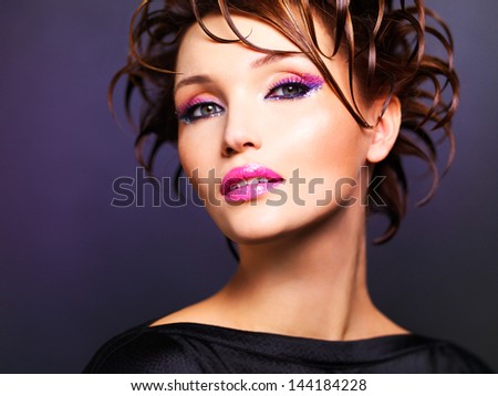 Beautiful woman with fashion  bright pink makeup - posing at studio.