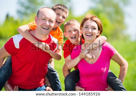 Happy family with two children on nature - happiness concept