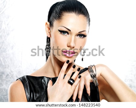 Beautiful fashion sexy woman with black nails at pretty face.