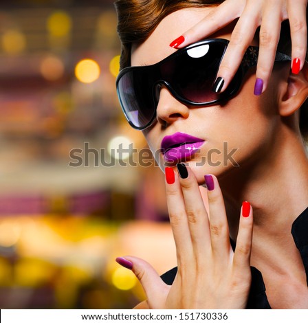 Face of young woman with  fashion manicure and black sunglasses