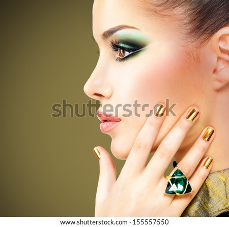 Glamour Woman With Beautiful Golden Nails And Emerald Ring On Hands