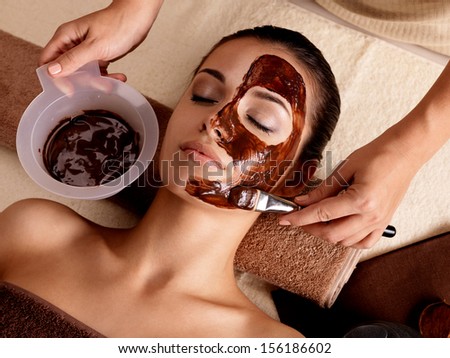 Spa therapy for young woman having facial mask at beauty salon indoors Spa therapy for young woman having facial mask at beauty salon indoors