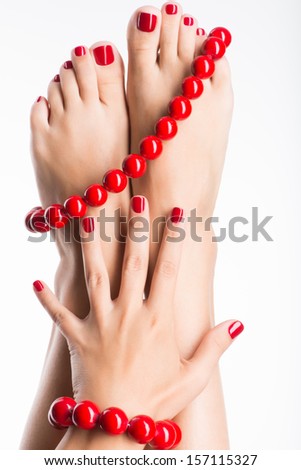 Closeup Photo Of A Female Feet With Beautiful Red Pedicure And Big Beads - Over White Background