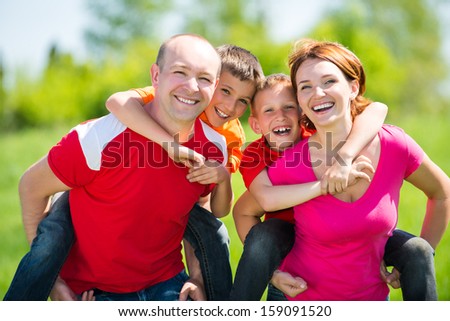 Happy Family With Two Children On Nature - Happiness Concept