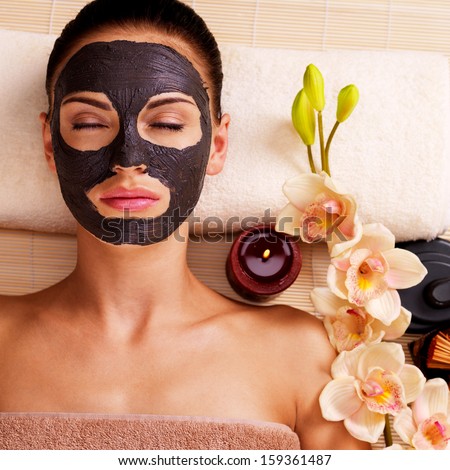 Adult Woman Relaxing In Spa Salon. Female Face With Cosmetic Mask. Beauty Treatment
