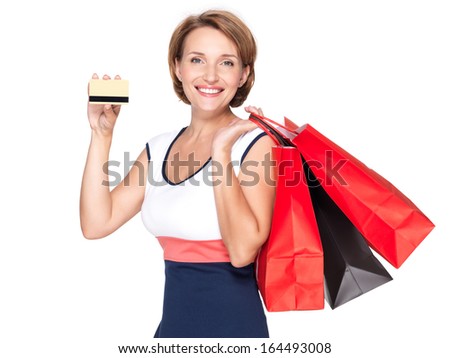 Happy white woman with shopping  bags and credit card over white background