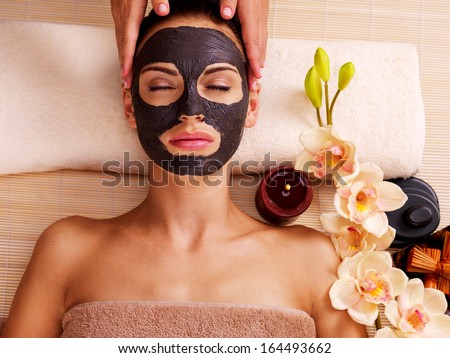 Cosmetologist Doing Massage On The Woman\'S Face In Sap Salon. Female With Scrub Cosmetic Mask On Face.