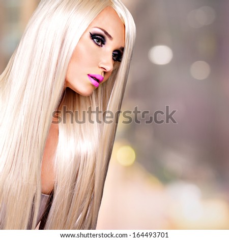 Portrait of  a  beautiful adult woman with long white straight  hairs.  Face of a Fashion model with pink lipstick. Pretty girl posing at studio.