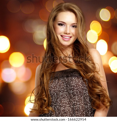 Beautiful Young Smiling Woman With Long Hairs Looking At Camera. Studio Portrait.