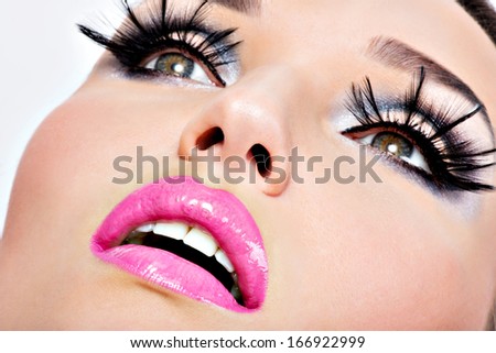 Beautiful woman with bright fashion eyes and lips make-up