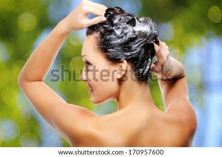 Beautiful Young Woman Soaping Her Head Over Nature Green Background