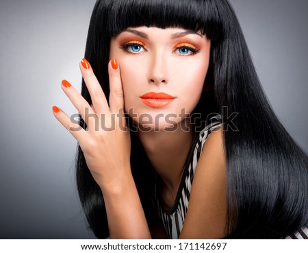 Studio Portrait Of A Beautiful Woman With Red Nails, Glamour Makeup And Long Black Hair.