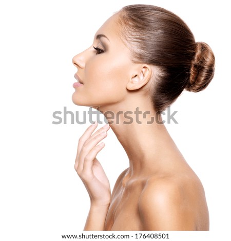 Profile of a beautiful young woman with fresh clean skin gently touching her neck isolated on white Profile of a beautiful young woman with fresh clean skin gently touching her neck isolated on white