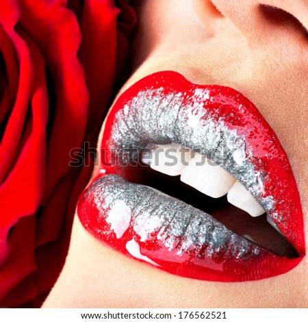 Closeup beautiful female lips with shiny red gloss lipstick and rose