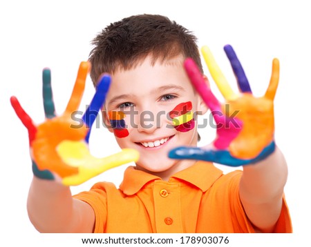Happy smiling boy with a painted hands and face in orange t-shirt - on a white background.