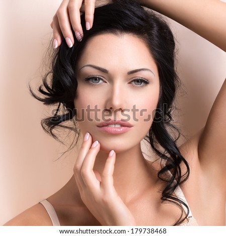Portrait of a beautiful sexy tender woman with creative hairstyle. Model posing at studio
