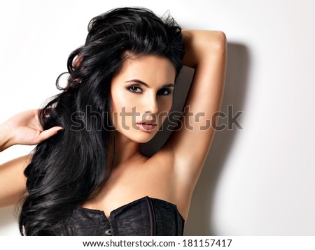 Beautiful sexy  young brunette woman with long  hair.  Portrait of a pretty fashion model posing at studio.