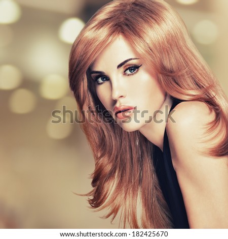Portrait of a beautiful woman with long straight red hair. Fashion model instagram styling
