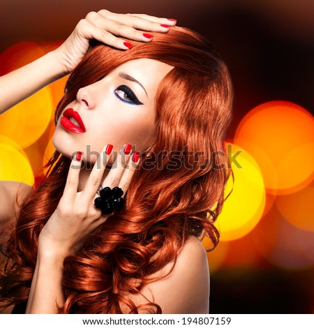 Beautiful sensual woman with long red hairs and red nails -  on art blink night lights