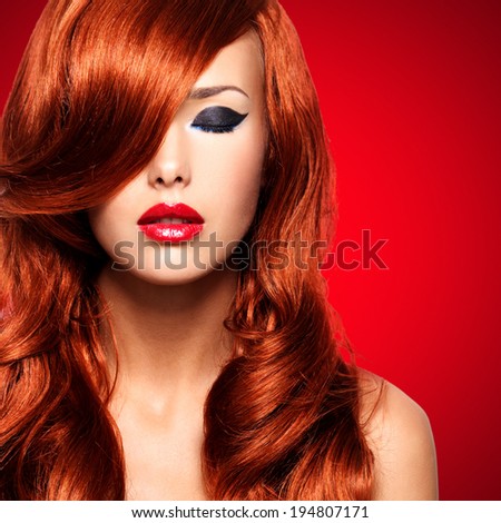 Portrait  of beautiful  woman with long red hairs and red lips. Calm face  of adult pretty girl