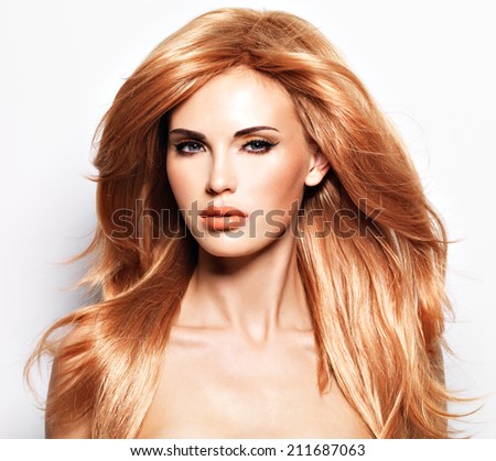 Portrait of a beautiful woman with long straight red hair and glamour makeup . Fashion model over white background