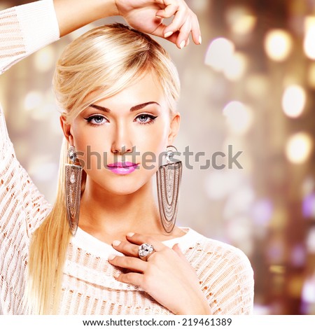 Portrait of a beautiful woman with bright pink lips and  fashion makeup. Model posing at studio on the art background