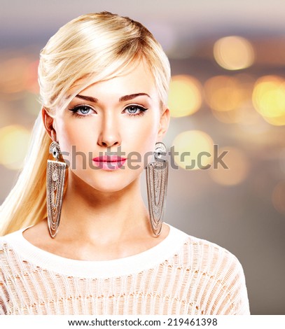 Portrait of a beautiful woman with bright pink lips and  fashion makeup. Model posing at studio on the art background