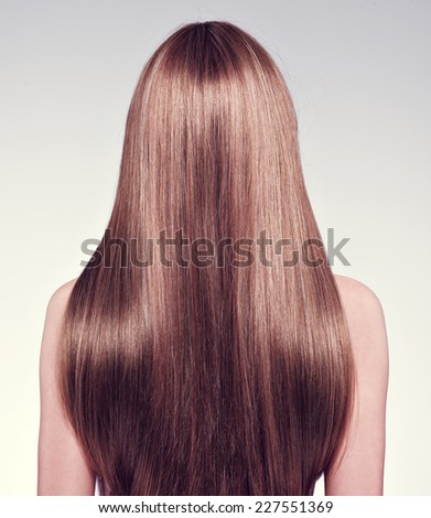 Rear view  of the woman with long  hair - studio