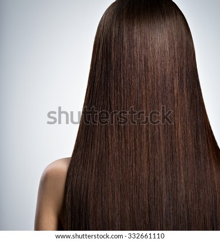 Rear Portrait of  woman with long brown straight  hair at studio