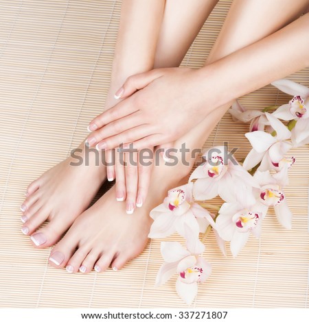 Closeup photo of a female feet at spa salon on pedicure and manicure procedure - Soft focus image