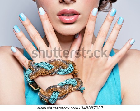 woman hands nails manicure fashion blue jewelry. Female hands with blue fingernails